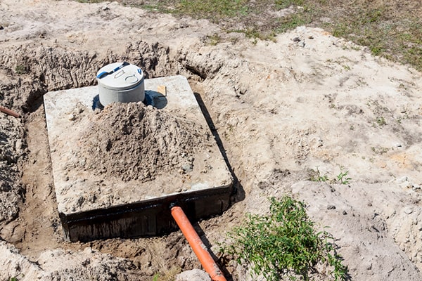 septic tank pumping involves using a vacuum truck to remove the sludge and scum buildup from the tank